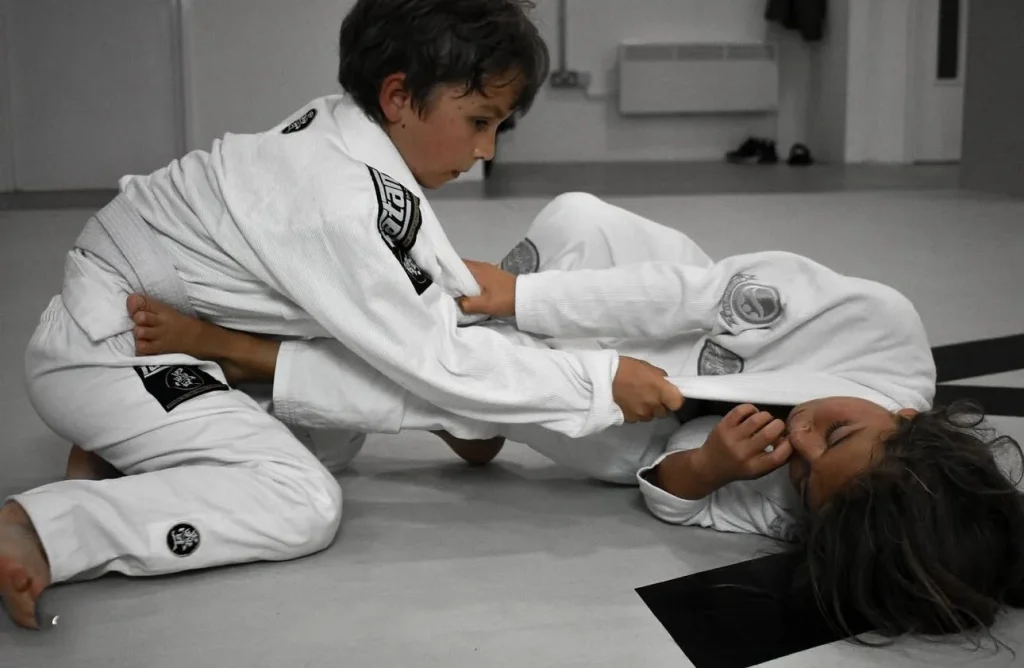 Two children training BJJ.