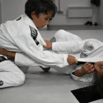 Two children training BJJ.