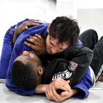 Two adults doing BJJ technique