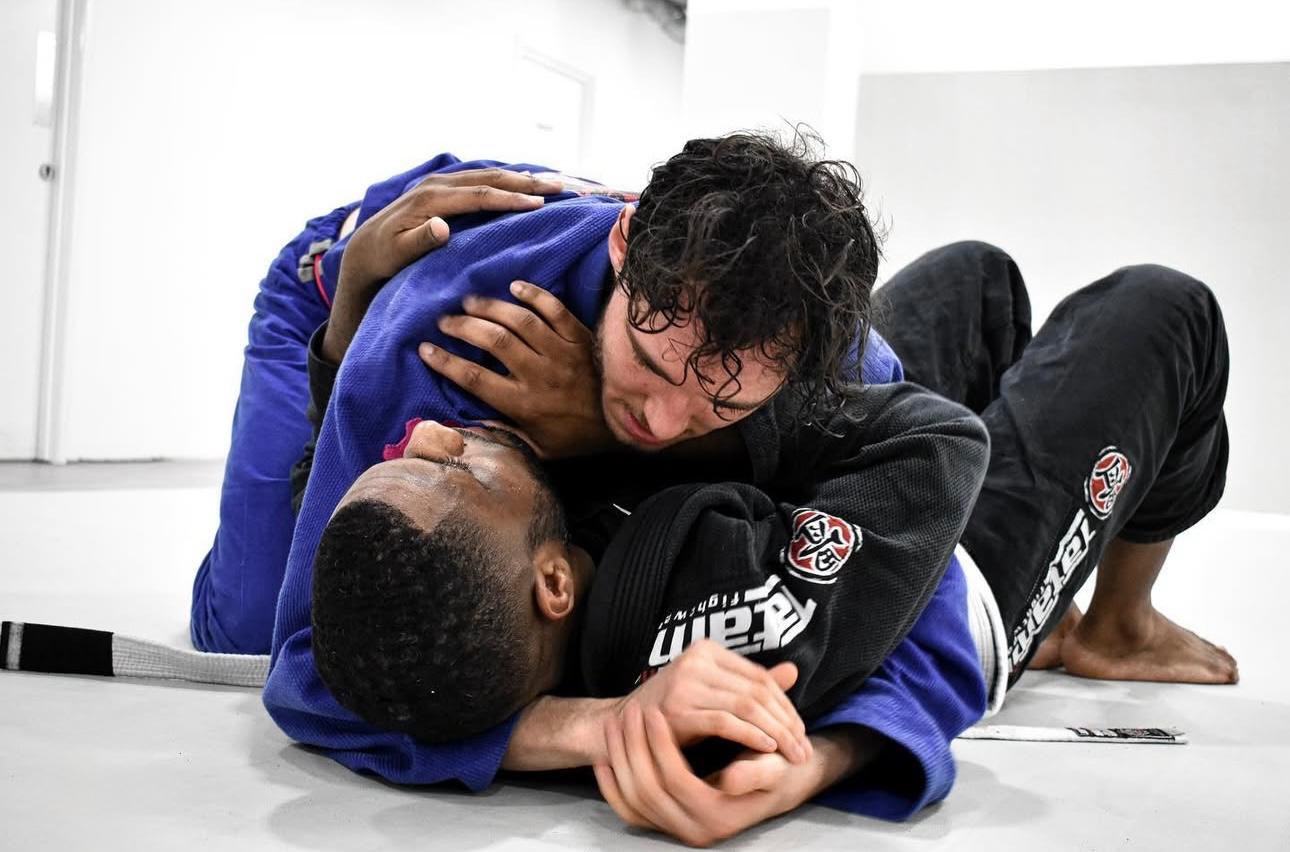 Two adults doing BJJ technique