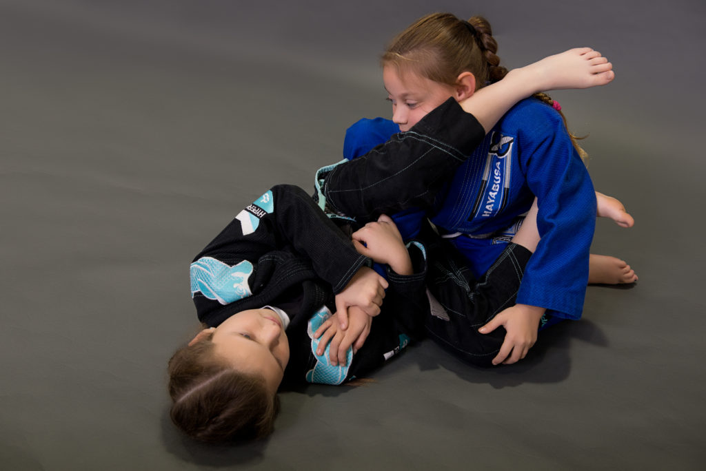 2 girls practising BJJ wearing Gi's